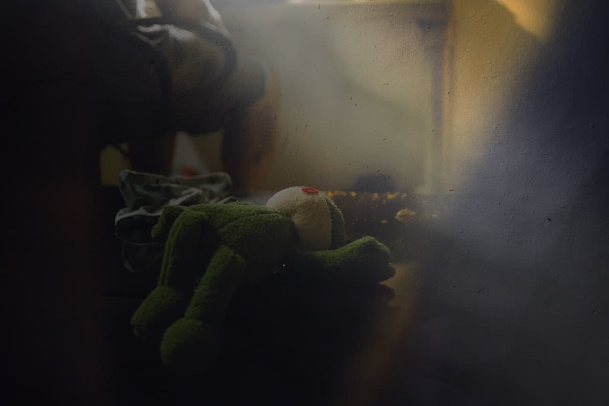 A perpetrator in his room, stuffed toy on the floor